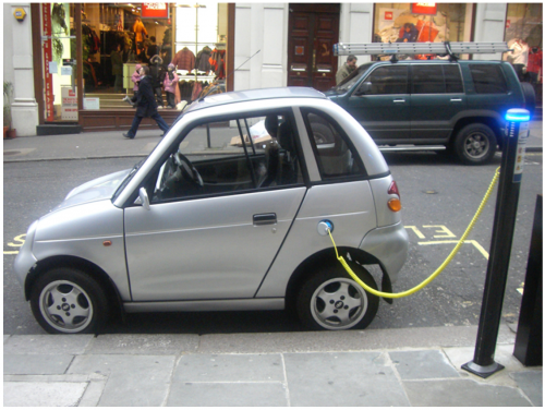 <b>Figure 20.44</b> This REVAi, an electric car, gets recharged on a street in London. (credit: Frank Hebbert)